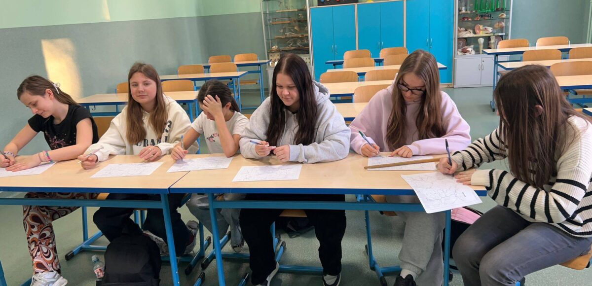 Uczennice z grupy „Eko-Ja” podczas zajęć ekologicznych w sali lekcyjnej pracują nad kartami zadań w ramach programu EduAkcja