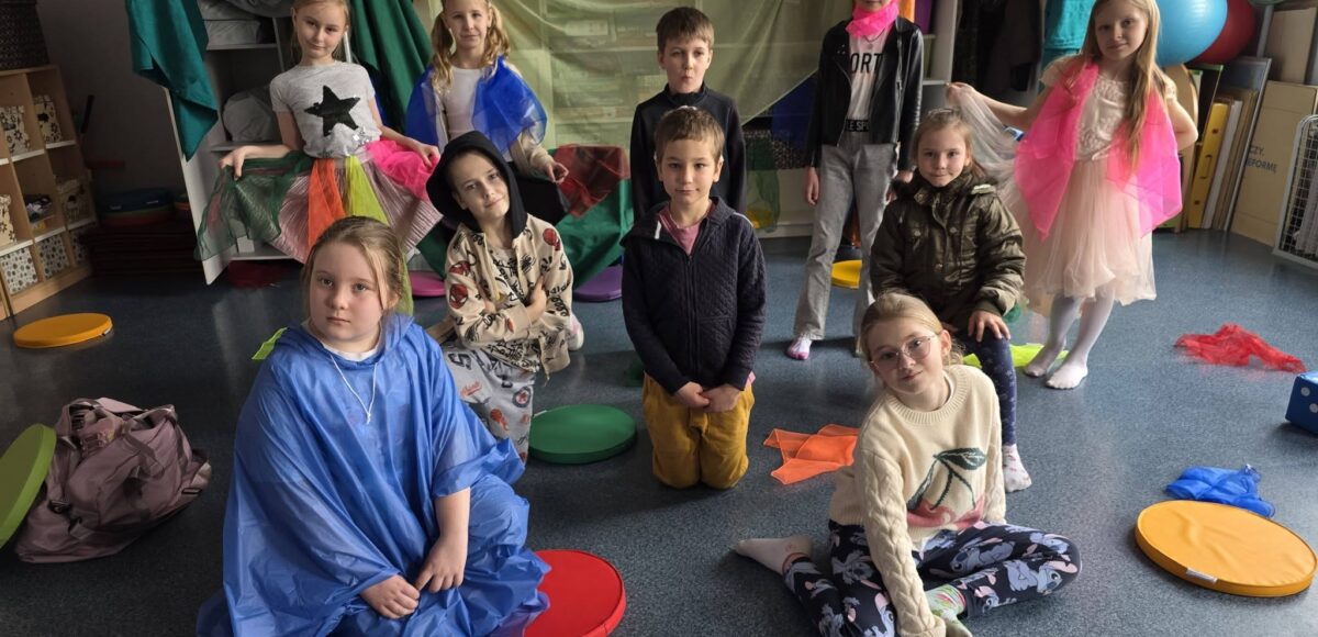 Uczniowie klasy 2 w kolorowych strojach podczas przedstawienia „Szafantura” z okazji pierwszego dnia wiosny.