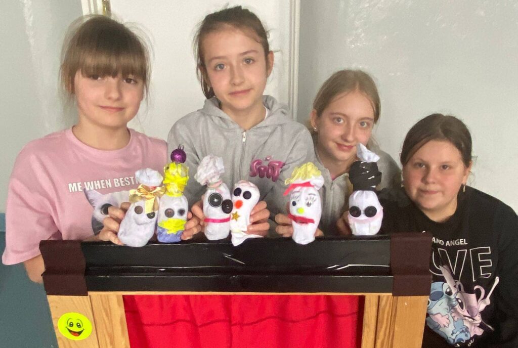 Uczniowie klasy 4a prezentują własnoręcznie wykonane pacynki i scenki w szkolnym teatrze lalek podczas zajęć koła „Maskoteka”