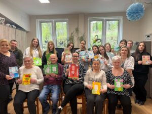 Uczennice klasy VI wspólnie z podopiecznymi Domu Pomocy Społecznej prezentują wykonane wiosenne kartki.