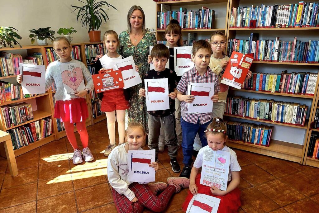 Uczniowie klasy II prezentują prace o polskich symbolach narodowych podczas zajęć w bibliotece