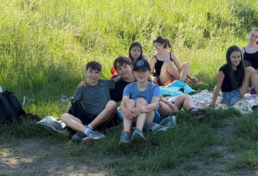 Uczniowie klasy VI odpoczywają na kocach podczas wspólnego wyjścia na Kamionkę w ostatnim dniu nauki.